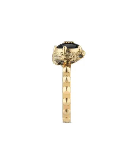 Bague Gucci Le Marché des Merveilles en or jaune, ornée d'onyx noir et de diamants, représentant une tête de félin.